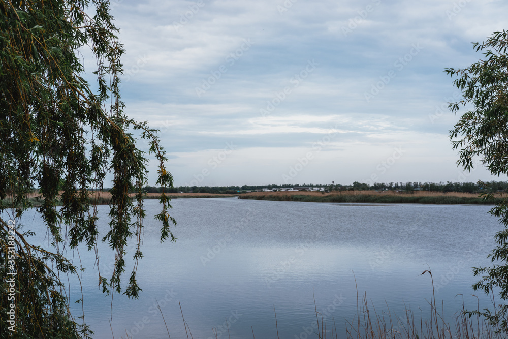 Clear blue river and blue cloudy sky