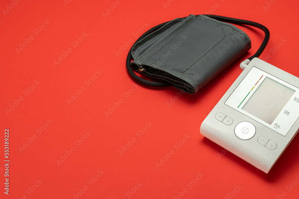 Pressure meter. Patient test hypertension from medical sphygmomanometer. Health monitor for check doctor blood pressure isolated on red background. Hospital diagnostic technology. Pressure meter. Patient test hypertension from medical sphygmomanometer. Health monitor for check doctor blood pressure isolated on red background. Hospital diagnostic technology.