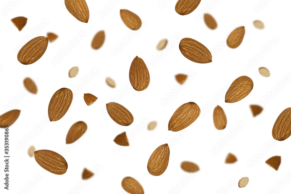 Falling almonds isolated on a white background with clipping path as package design element and advertising. Flying food Falling almonds isolated on a white background with clipping path as package design element and advertising. Flying food