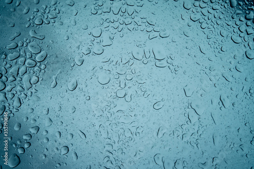 Water drops on the glass. Fogged glass in winter.