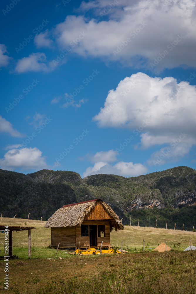 Farm houses and agricultural land in the Vinales Valley, know for its unique mountain karst formations called magote, Cuba Farm houses and agricultural land in the Vinales Valley, know for its unique mountain karst formations called magote, Cuba