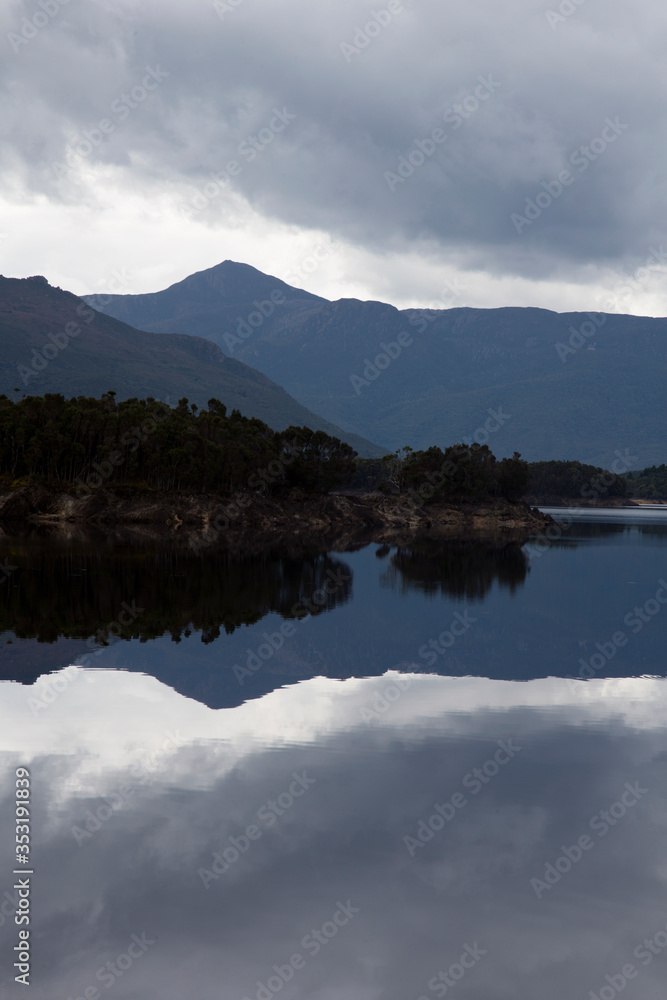 Amazing clouds and mountains reflected in Lake Burbury in Tasmania, Australia