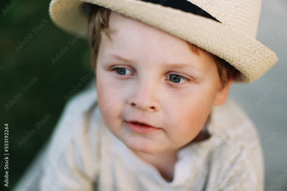 Closeup portrait of a smiling boy outdoors. A beautiful cute boy in a hat Closeup portrait of a smiling boy outdoors. A beautiful cute boy in a hat