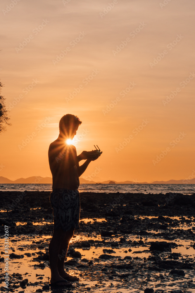 Fototapeta premium Tourist with a drone control at Railay beach, Thailand