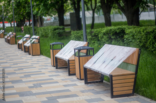 Park benches wrapped in connection with the coronavirus pandemic. social distance, forbidden to sit down, covid-19 © yfcnz1799