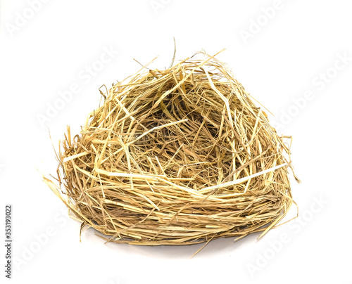 bird's nest or hen house made from dry straw golden color. Isolated on white background.