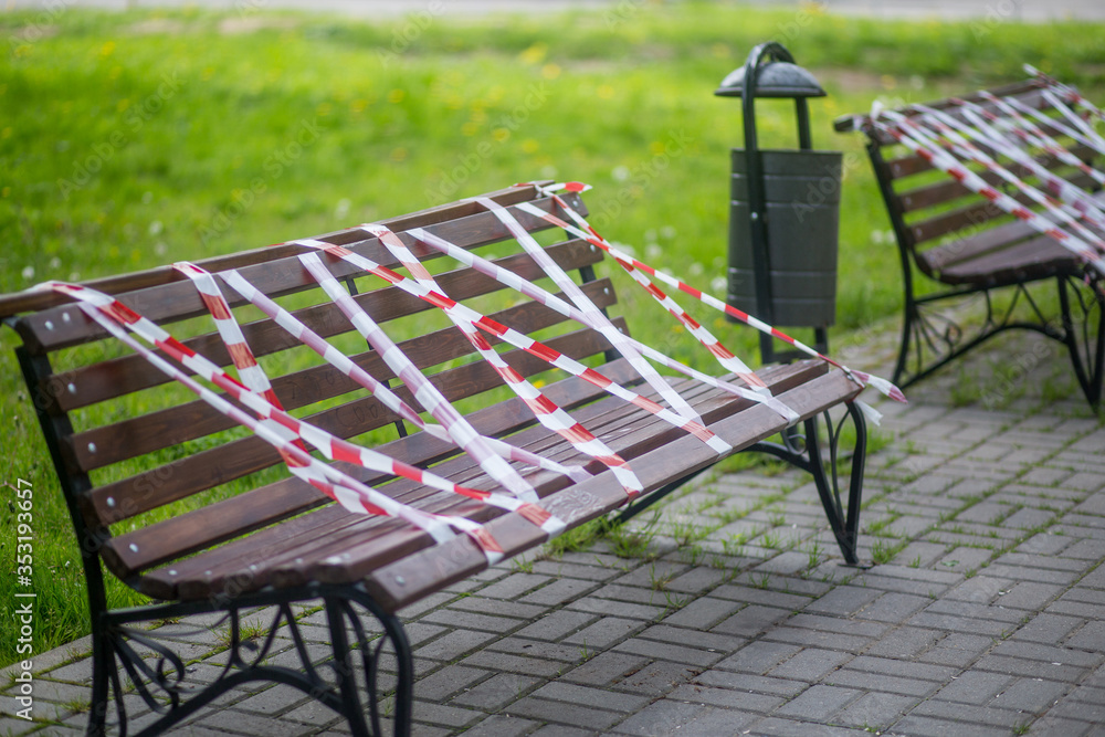 Park benches wrapped in connection with the coronavirus pandemic. social distance, forbidden to sit down, covid-19