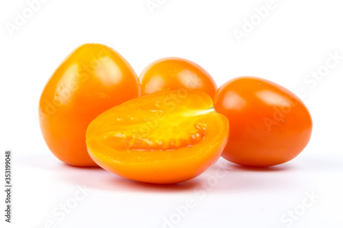 Yellow fresh tomatoes isolated on white background in close-up