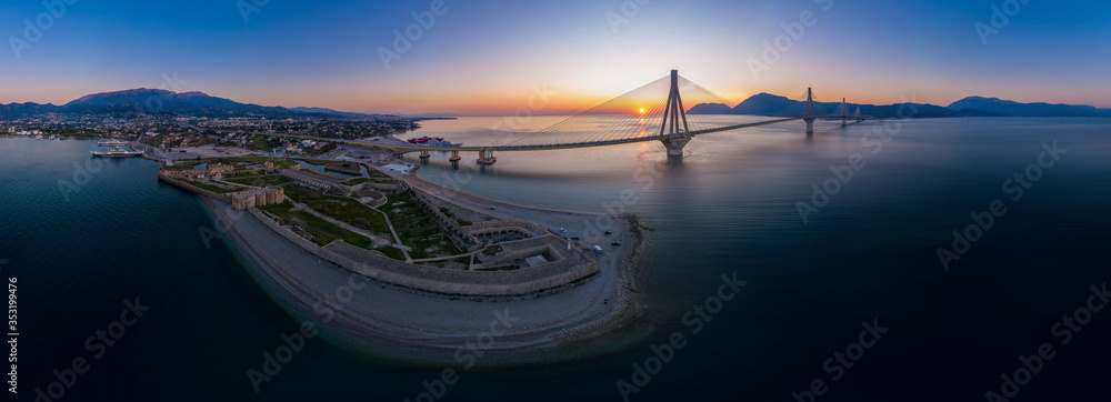 Wide panorama of world famous  Rio - Antirio Harilaos Trikoupis bridge at sunset time - obrazy, fototapety, plakaty 