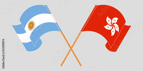 Crossed and waving flags of Hong Kong and Argentina