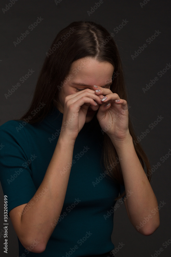 Studio portrait of a young girl with long hair on black background Studio portrait of a young girl with long hair on black background