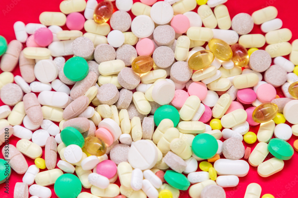 Medical pills on red background. Top view. Medicine concept Medical pills on red background. Top view. Medicine concept