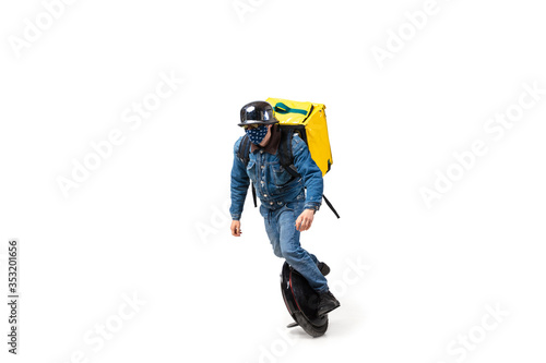Too much orders. Contacless delivery service during quarantine. Man delivers food wearing gloves and face mask isolated on white. Taking pizza on unicycle isolated on white background. Safety.