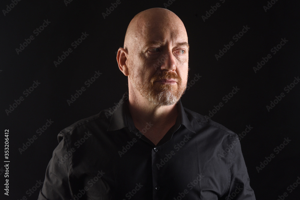 portrait of a man in low key and looking side