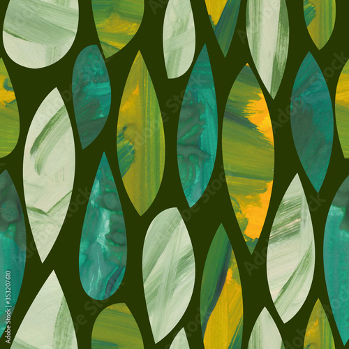 The seamless green leaf pattern is drawn in the gouache collage technique. A texture pattern of foliage is isolated on a dark background