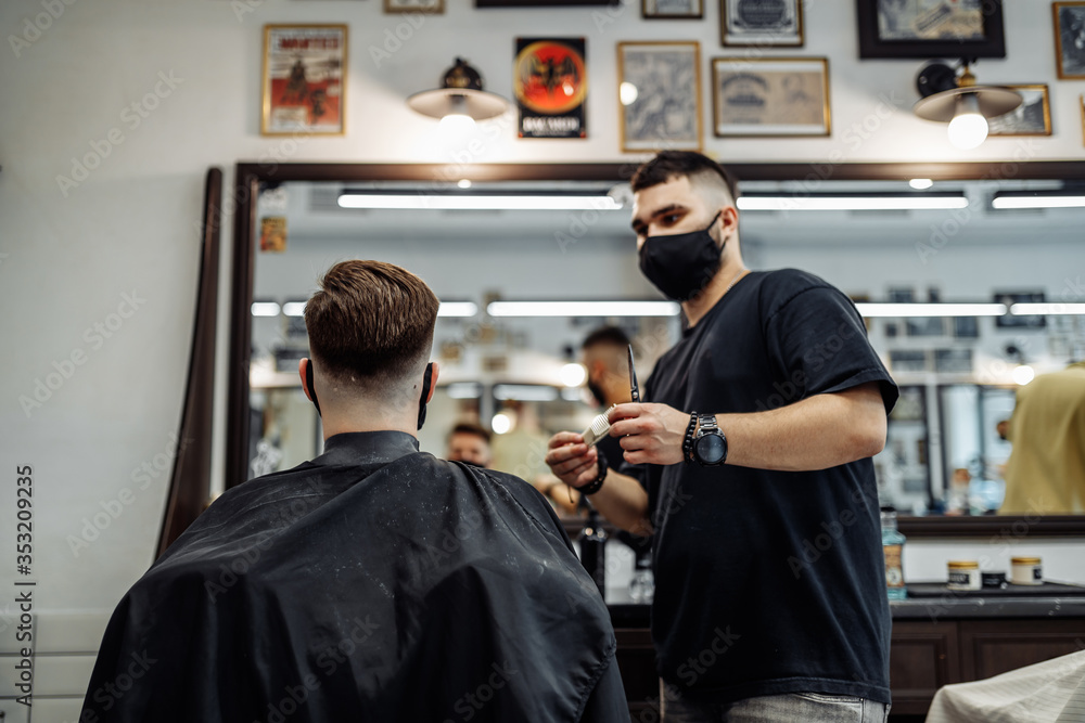Barber makes a haircut and hair styling in a barbershop, beauty salon. Barber makes a haircut and hair styling in a barbershop, beauty salon.