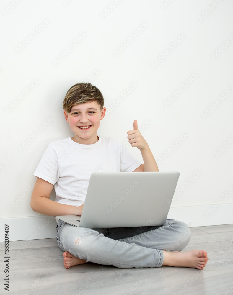boy with a laptop sitting and showing class. Boy colored hair on white background