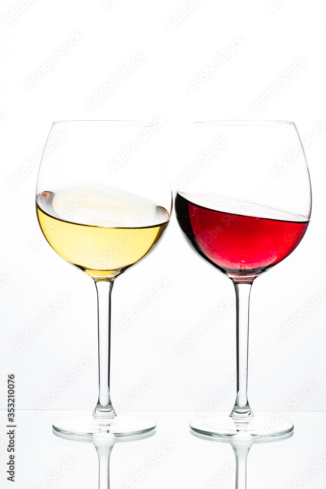 Two glasses with wine on a white background. Red wine. White wine. Apple juice. Cherry juice. Two glasses with wine on a white background. Red wine. White wine. Apple juice. Cherry juice.