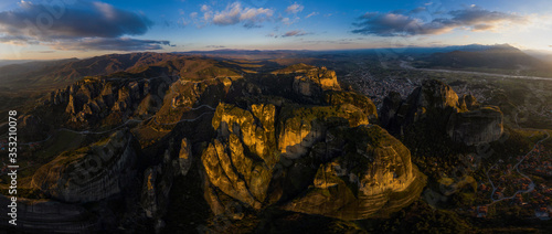 Mysterious wide panorama over rocks monasteries of Meteora, Greece at sunrise time