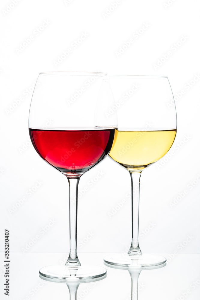Two glasses with wine on a white background. Red wine. White wine. Apple juice. Cherry juice. Two glasses with wine on a white background. Red wine. White wine. Apple juice. Cherry juice.
