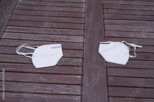 two kn95 protective masks on a wooden table photo