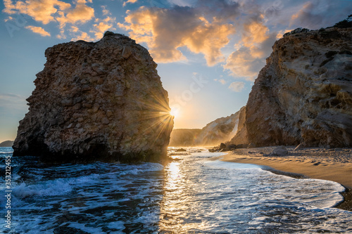 Fyriplaka beach and waves of Aegean sea on sunset, Milos island, Cyclades, Greece