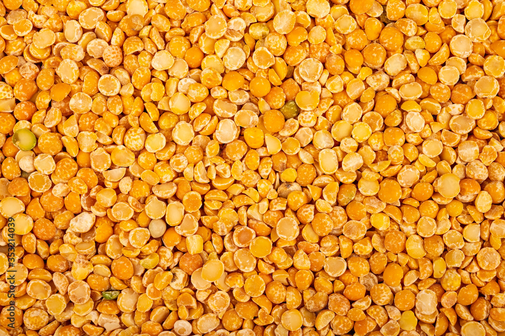 Yellow split peas, the texture of the surface. Traditional cereals for making soups and porridge. Close up. Yellow split peas, the texture of the surface. Traditional cereals for making soups and porridge. Close up.