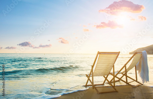 Background with couple of deck chairs at sunset  Travel concept  Summer background