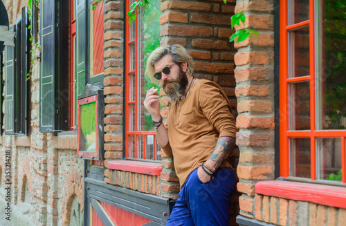 Smoking man. Sensual bearded man with cigarette. Cigarette. Bearded man smoke the cigarette. Sensual man smoking outside. Tobacco. Stylish bearded hipster with cigarette.