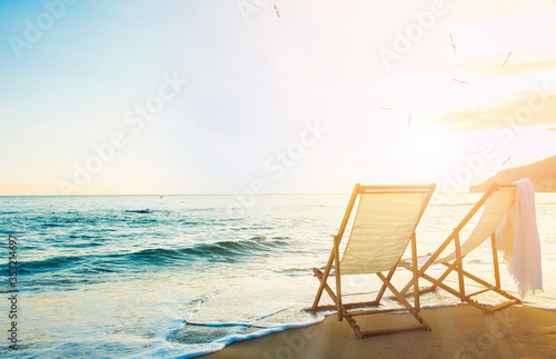 Background with couple of deck chairs at sunset  Travel concept  Summer background