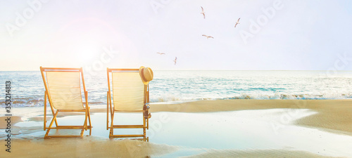 Background with couple of deck chairs at sunset, Travel concept, Summer background