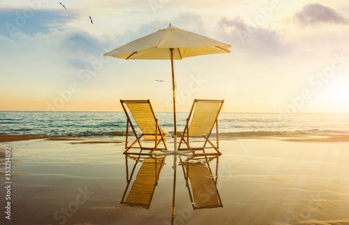 Background with couple of deck chairs at sunset, Travel concept, Summer background © Vladimir