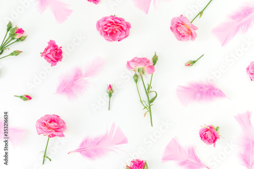 Fototapeta Naklejka Na Ścianę i Meble -  Pattern of pink roses with petals isolated on white background. Flat lay