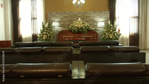 coffin with flowers in chapel