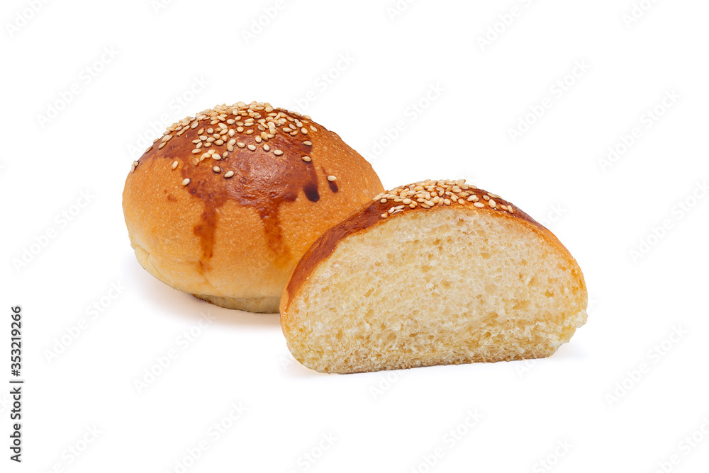 Traditional hamburger bread with sesame isolated on white background cut in half