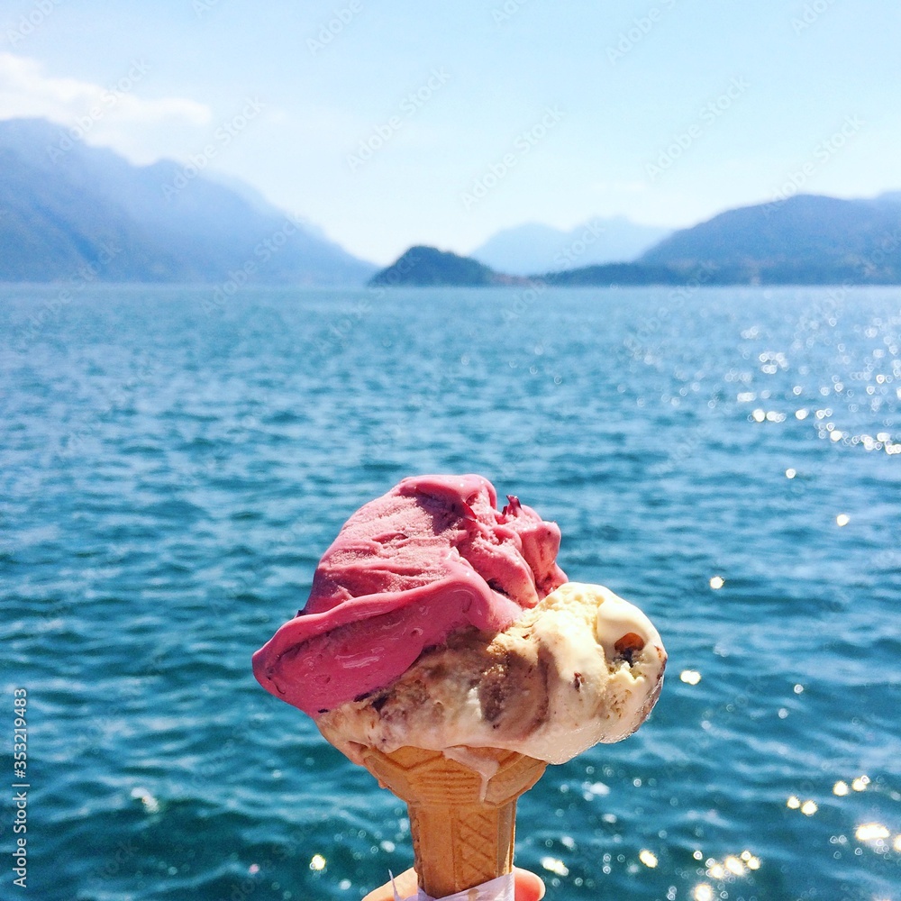melting ice cream cone with a lake and mountains view