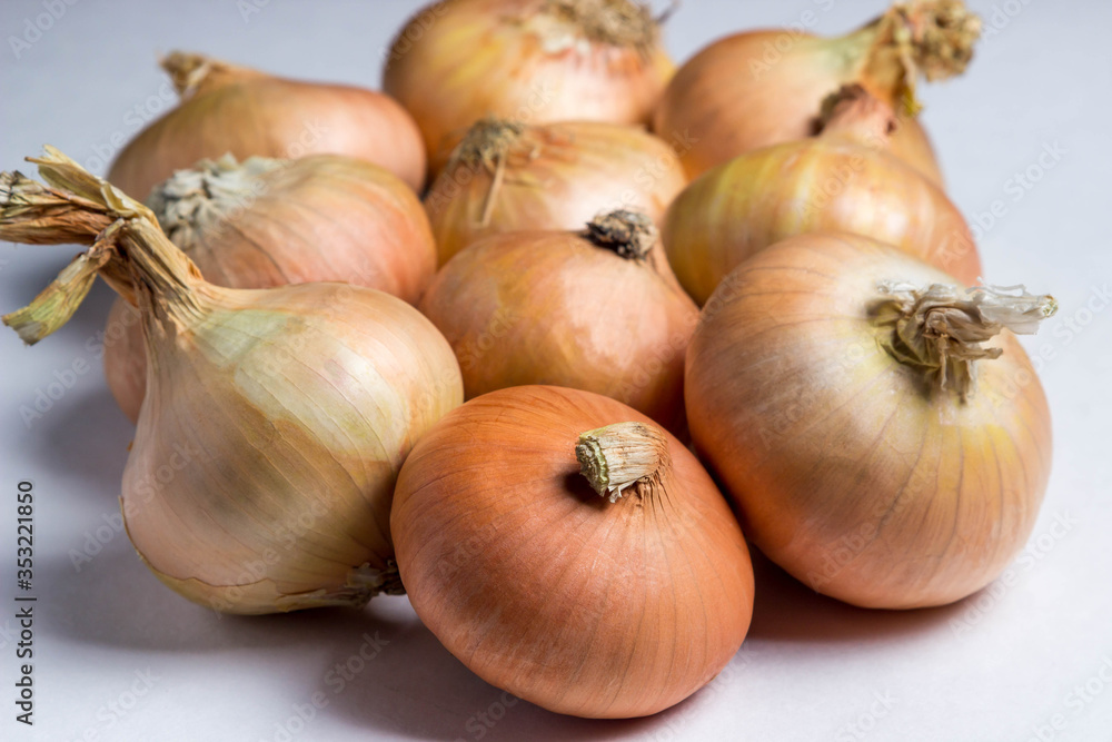 A lot of onions on a white background.
