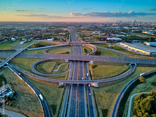 A beautiful panoramic aerial drone view of the sunset on the highway overpass of the southern Warsaw bypass (Polish: POW), Michalowice district in Warsaw, Opacz Kolonia, Poland
