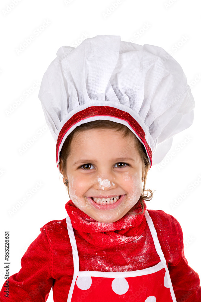 happy and smiling little girl making dough with cook's hat on white background happy and smiling little girl making dough with cook's hat on white background