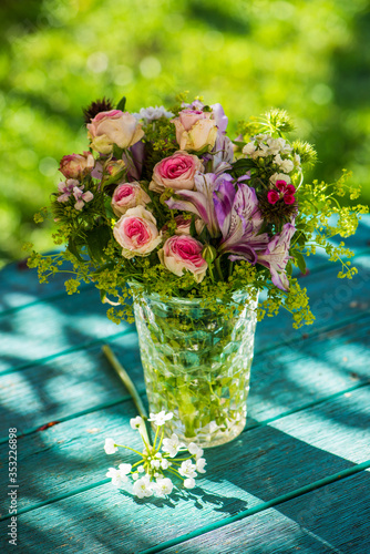 Fototapeta Naklejka Na Ścianę i Meble -  Little flower bouquet on a garden table