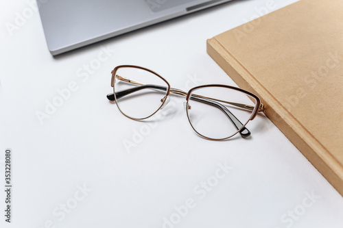 Glasses on the table near the laptop. Work office space.