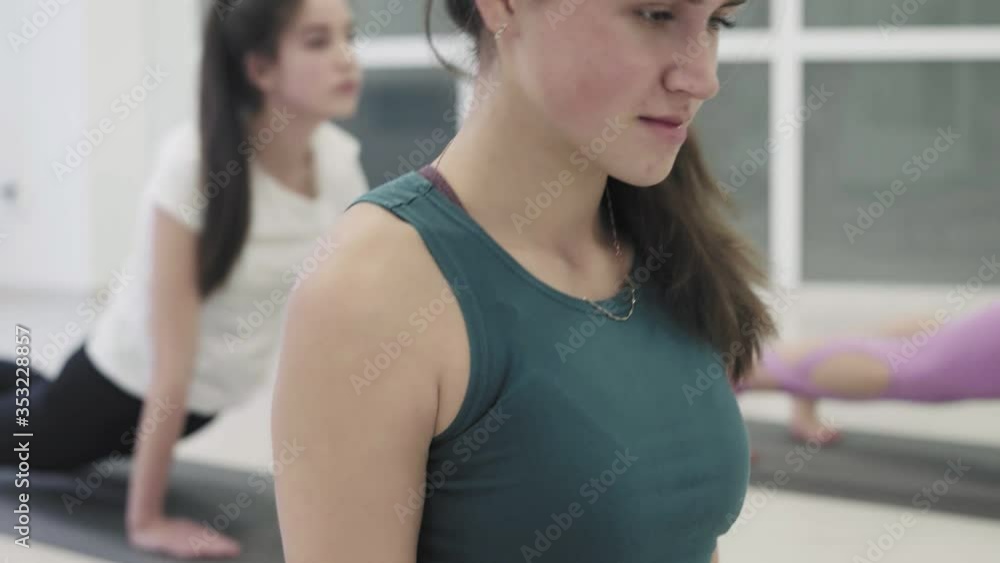 Beautiful women is practices yoga under supervision of coach in sports club. Beautiful women is practices yoga under supervision of coach in sports club.