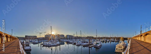 Panoramic image of Elizabeth Marina, St Helier early morning from the West marina wall with the entrance to the marina on the right hand side of the image. Jersey, Channel Islands, UK