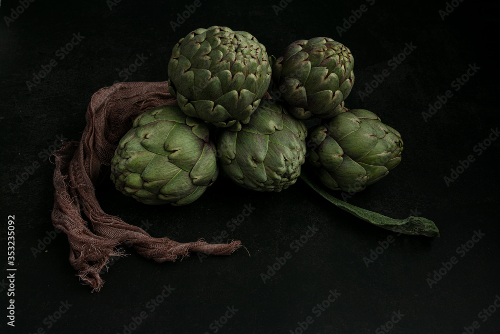 Fototapeta premium Three artichokes tied with a cloth