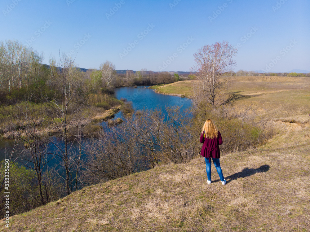 A woman by the lake. Aerial photography.