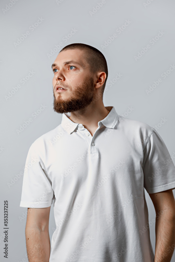 Portrait of a handsome young man looking attentively to the side on a white background. isolated. Portrait of a handsome young man looking attentively to the side on a white background. isolated.