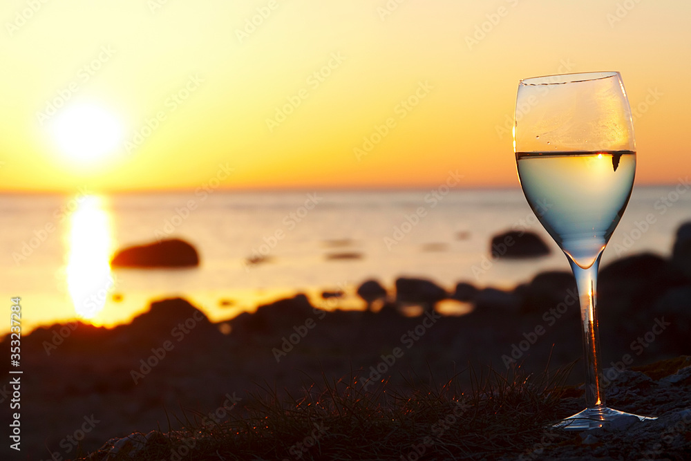 Wine glass with ocean sunset background