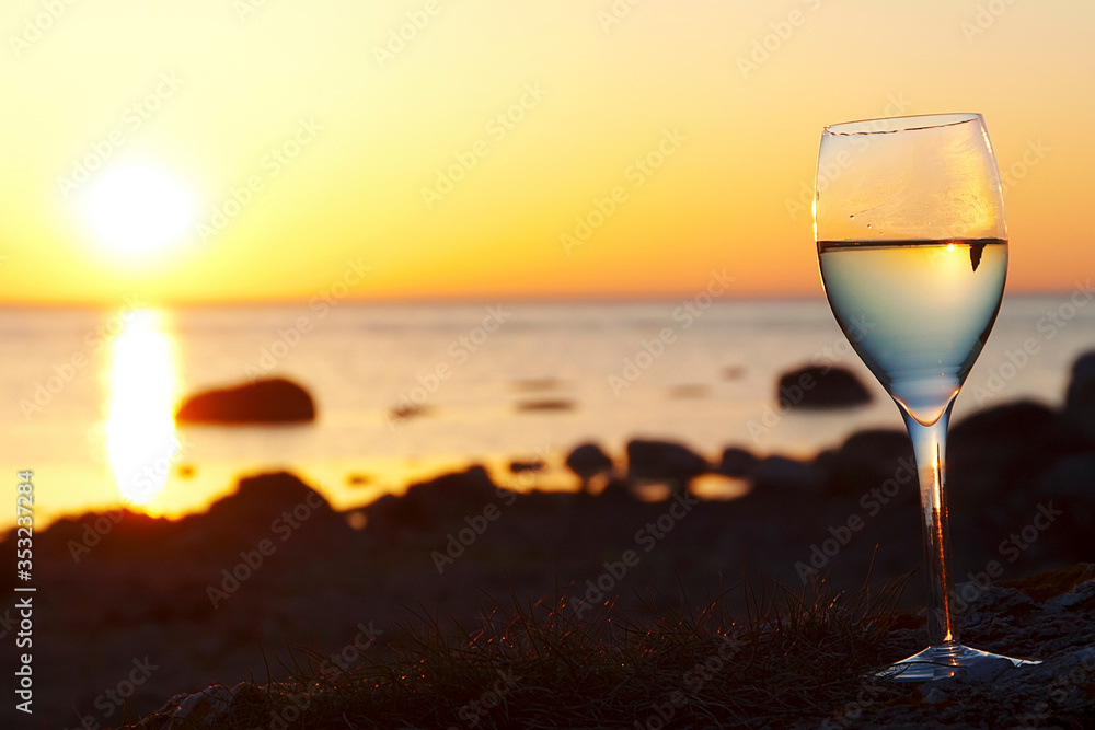 Wine glass with ocean sunset background Wine glass with ocean sunset background