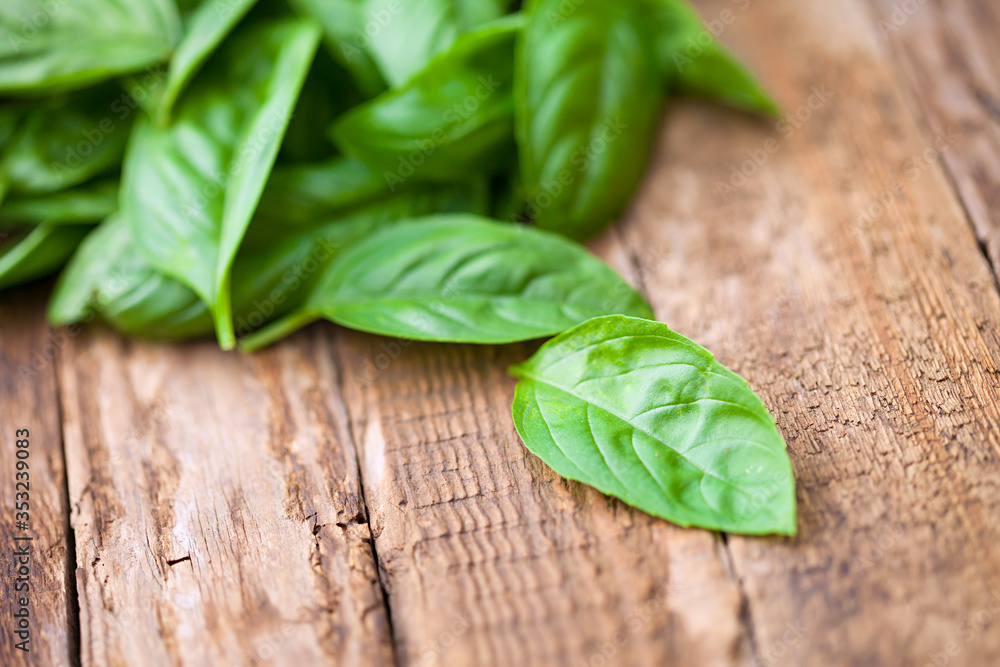 Fresh organic basilic leaves on a wooden surface. Fresh organic basilic leaves on a wooden surface.