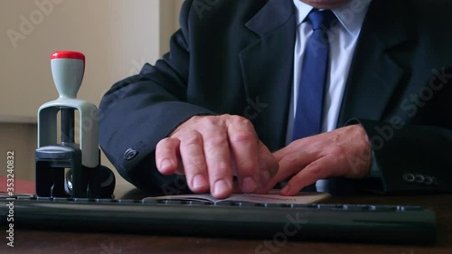 Close up. The immigration control officer verifies passport identification data.